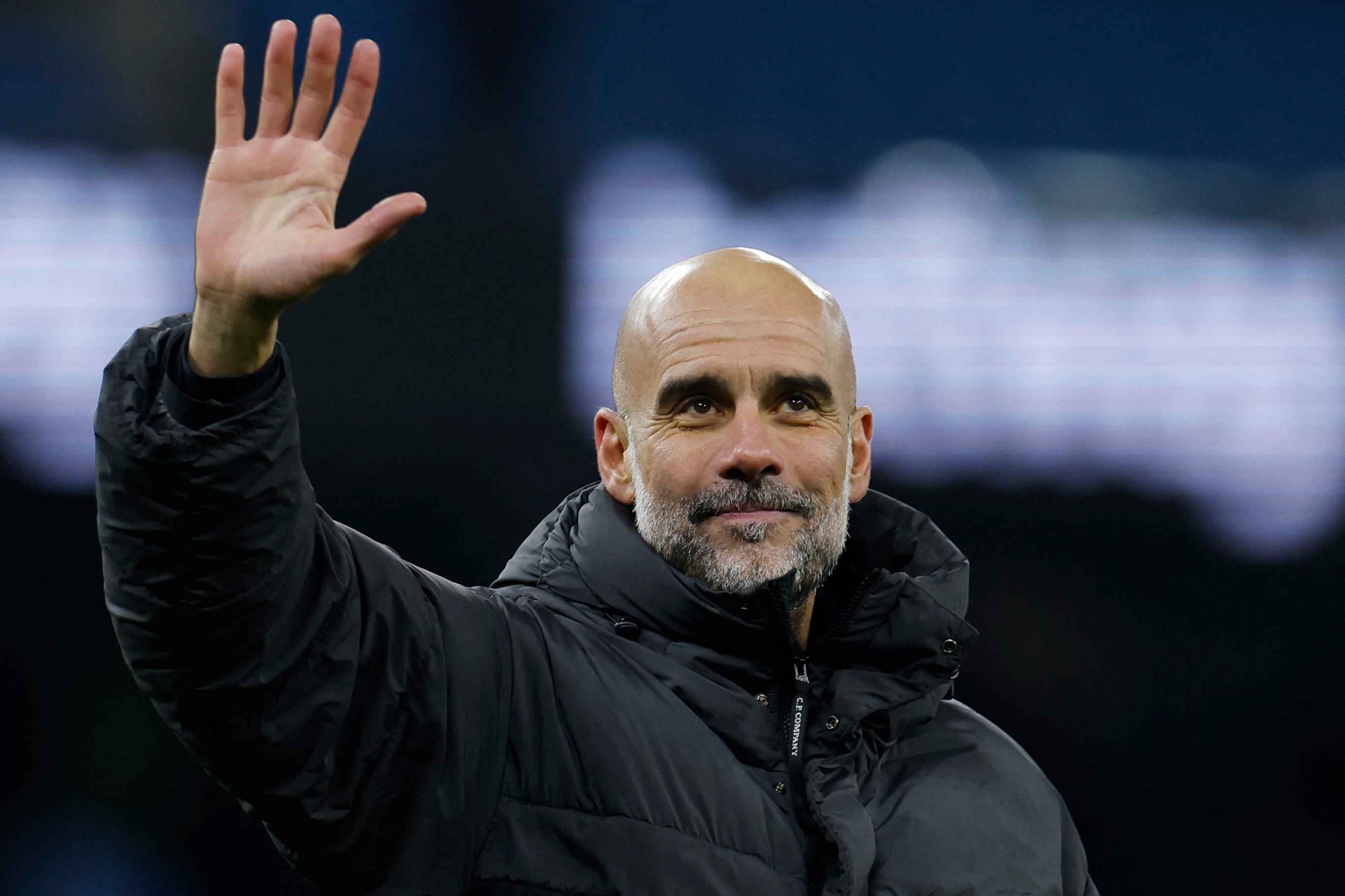 Pep Guardiola salutes the crowd after Manchester City's EFL Cup semi-final win.