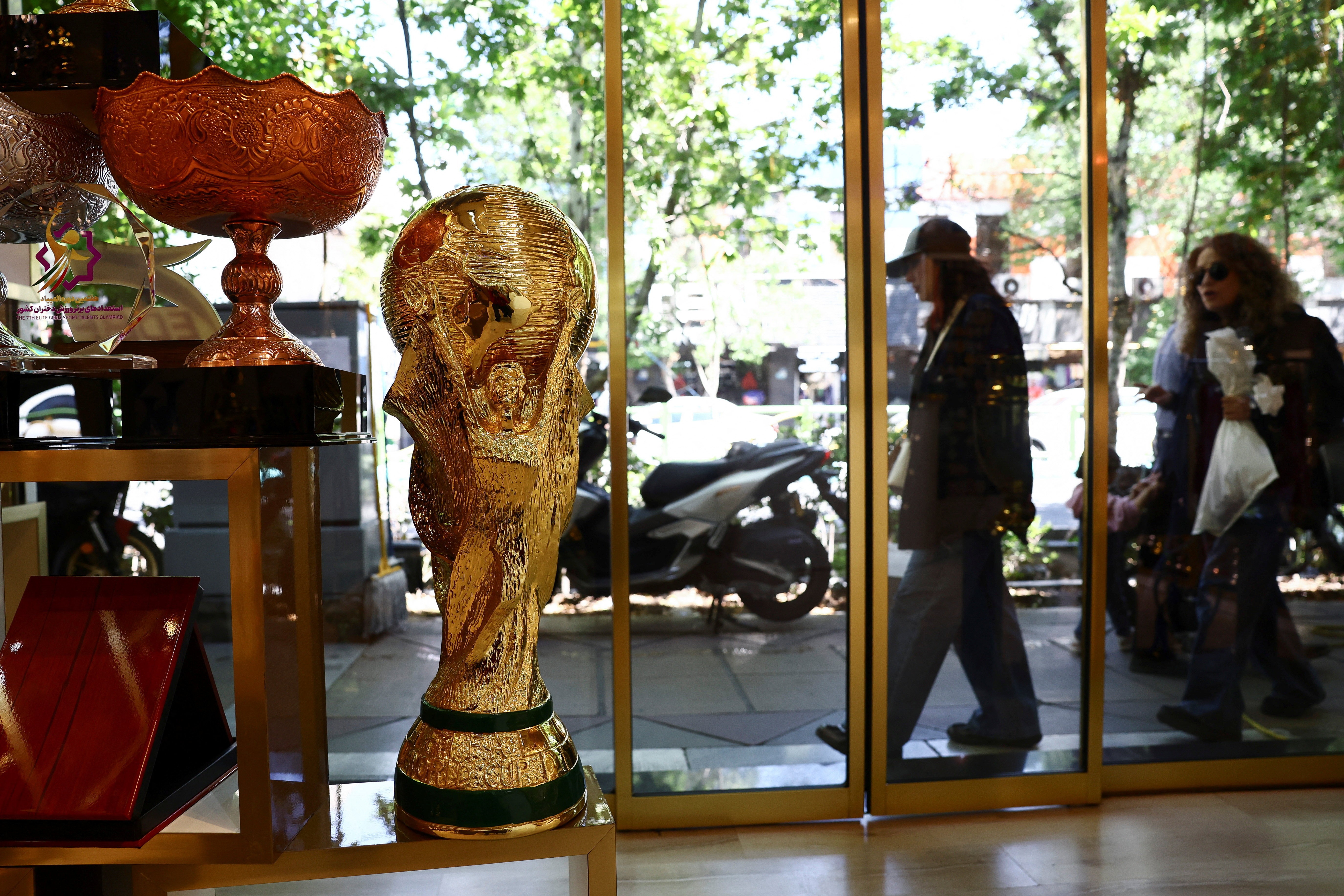 A replica of the FIFA World Cup trophy is displayed in a shop in Tehran, Iran