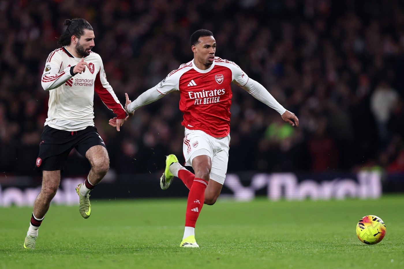 Arsenal's Gabriel tussles with Liverpool's Dominik Szoboszlai at the Emirates Stadium