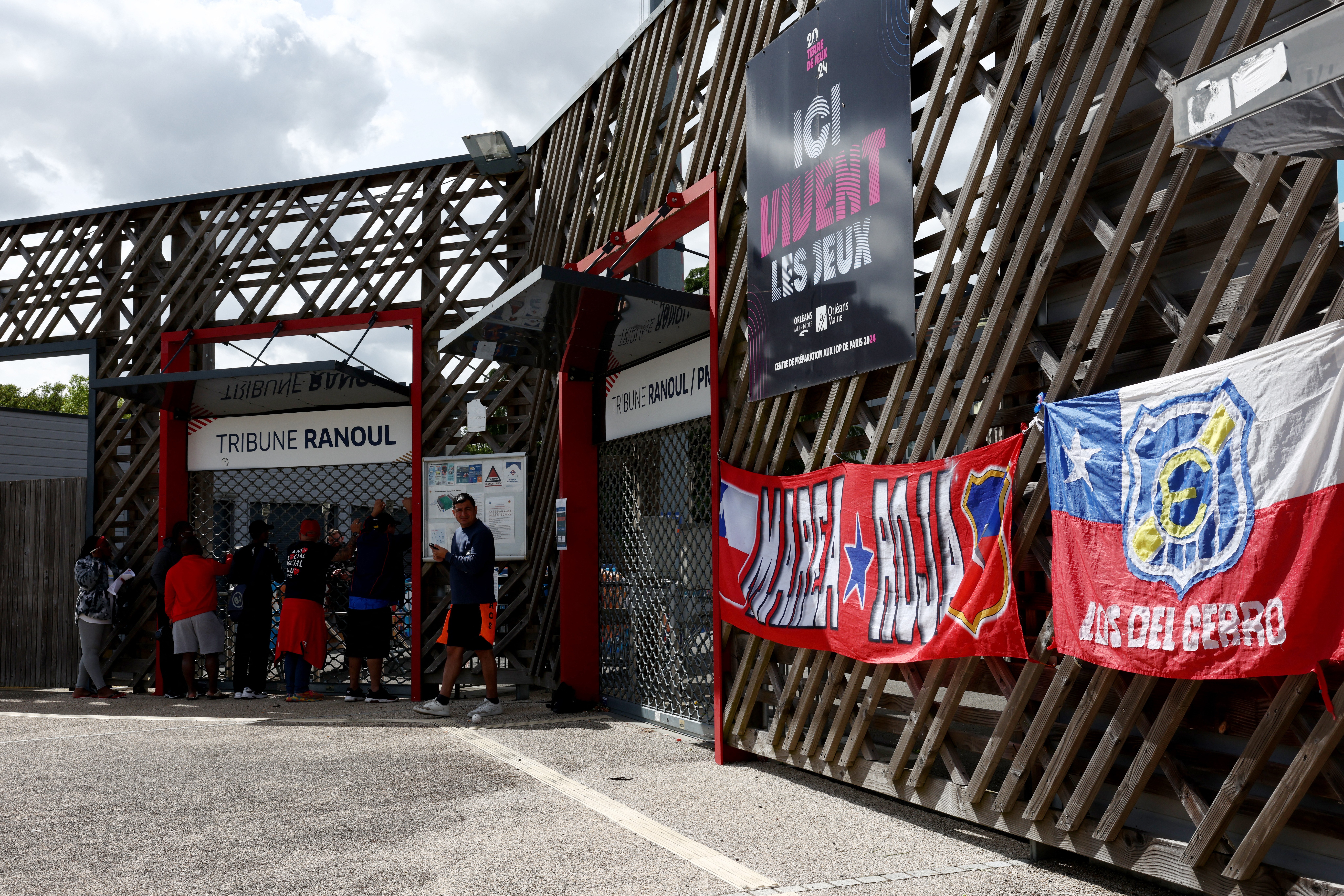 Fans gather outside the stadium before the match is played behind closed doors