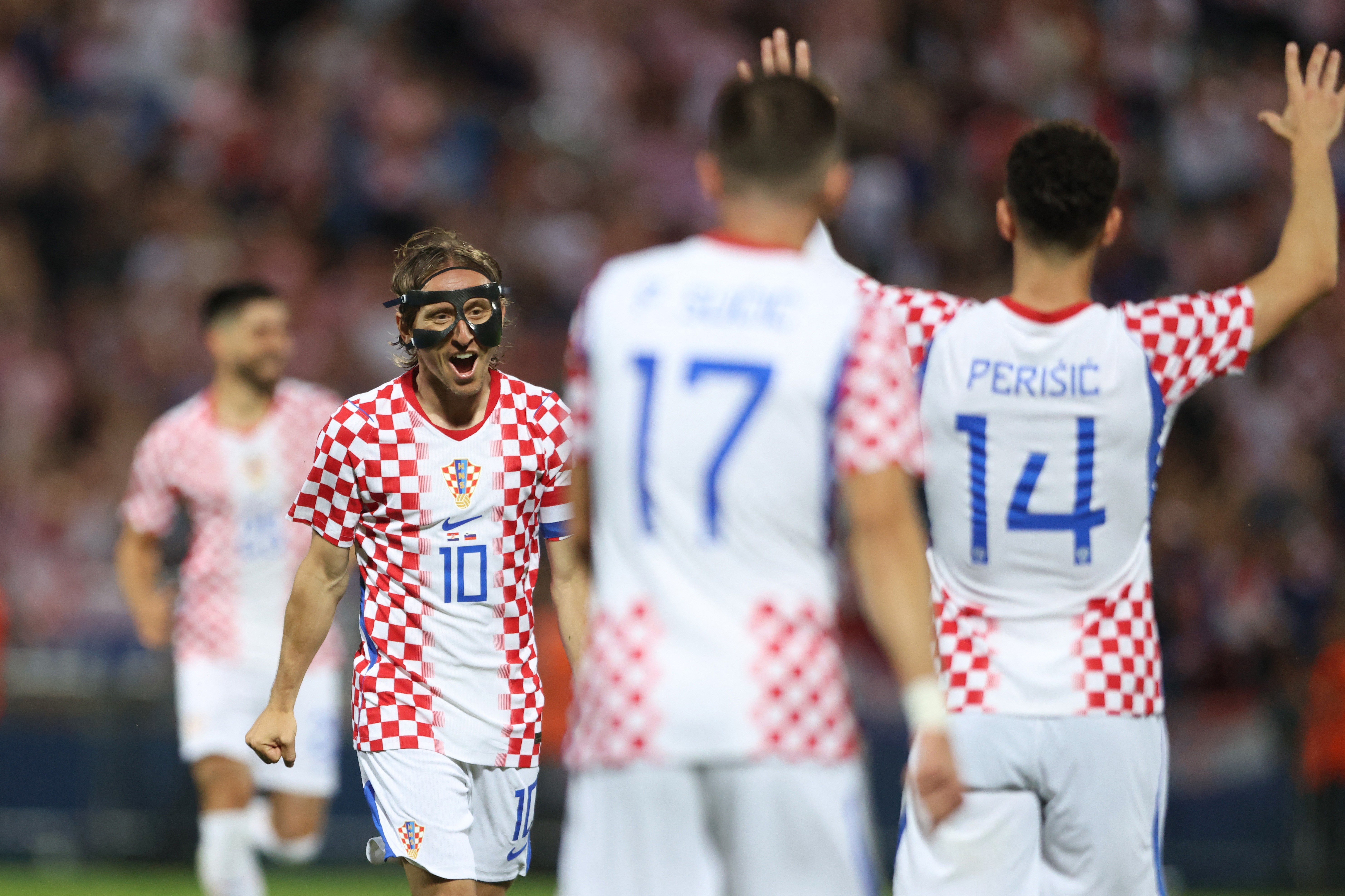 Modric (left) celebrates his goal