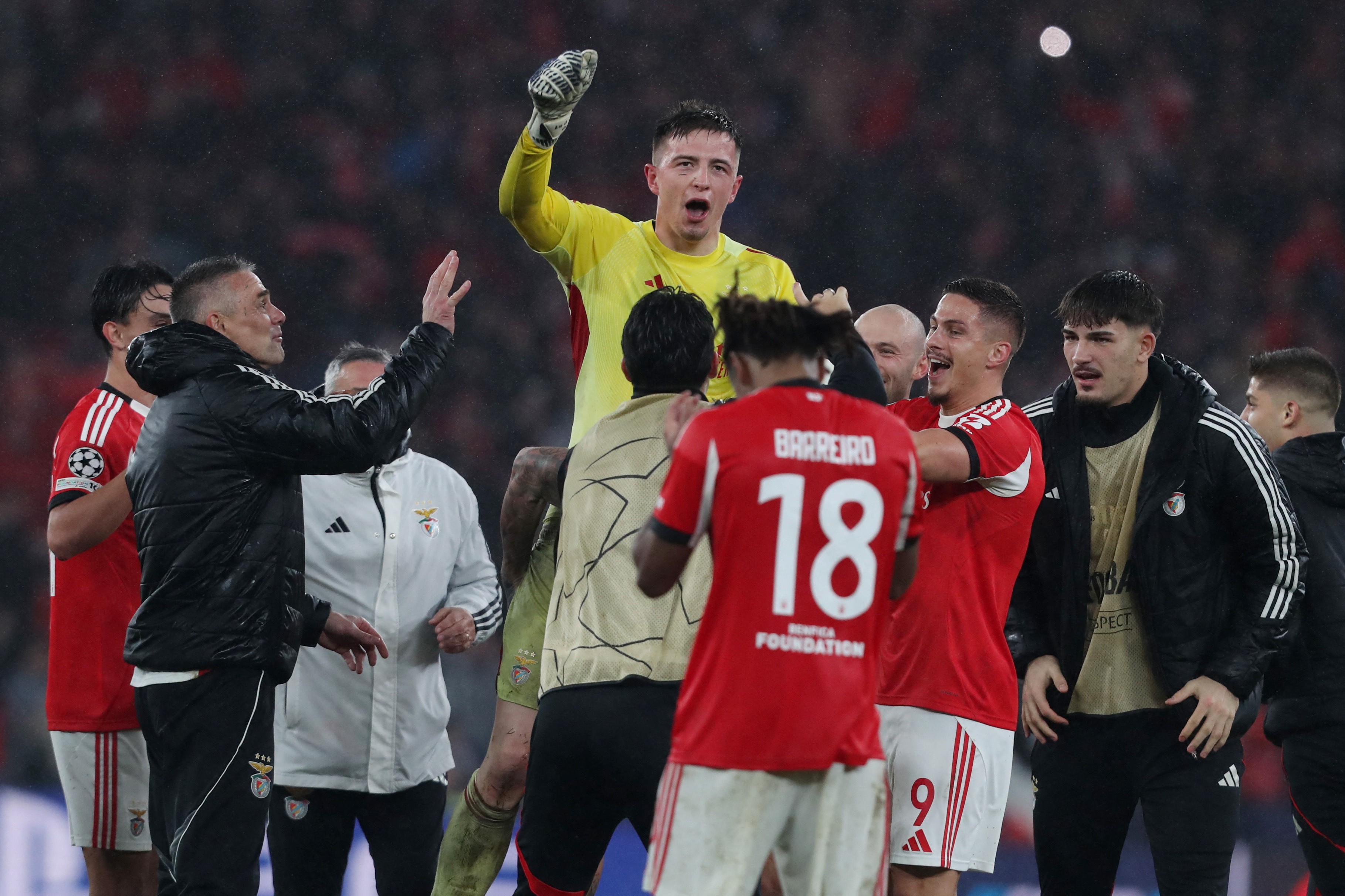 Benfica celebrate progressing to the knockout rounds of the Champions League.