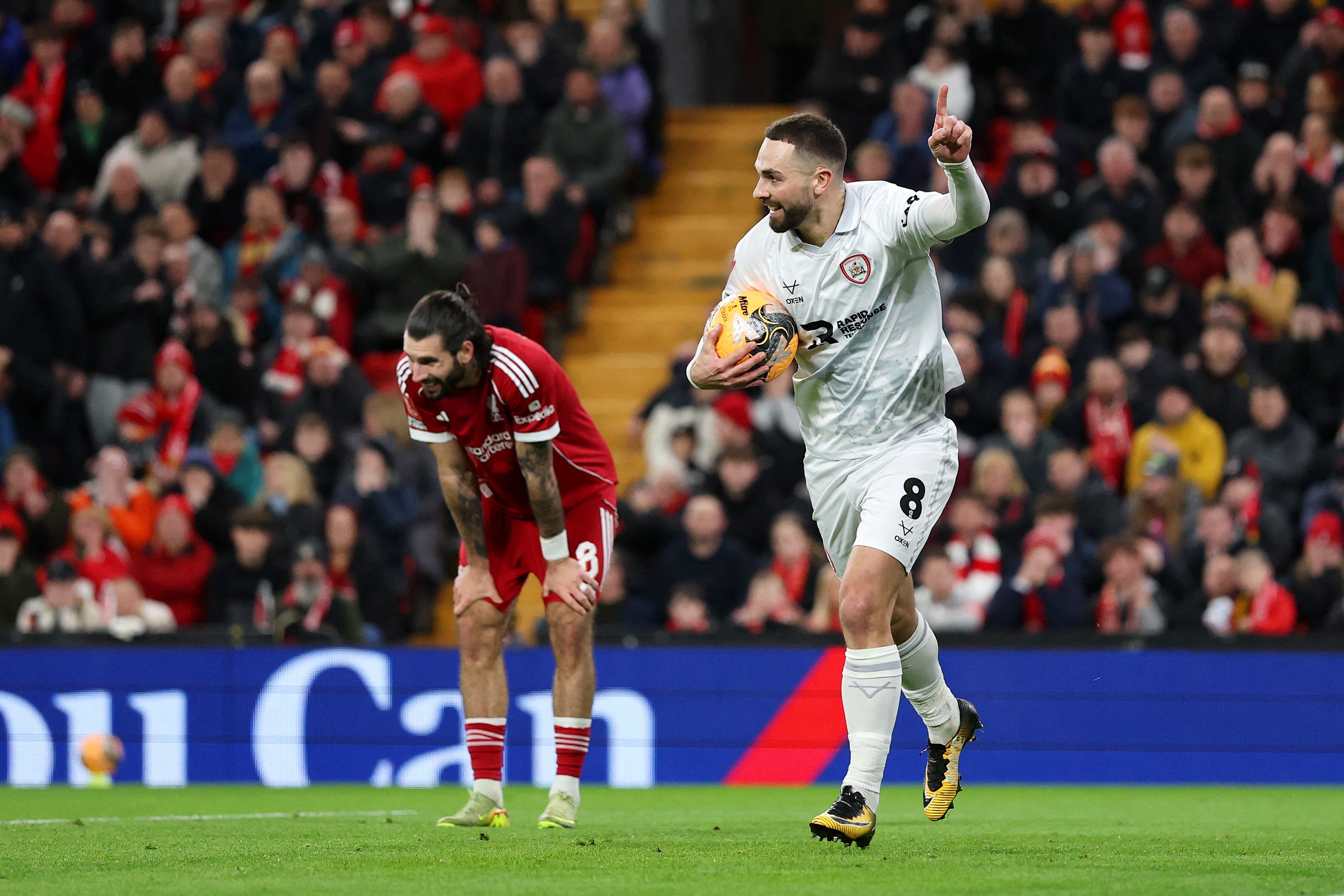 Barnsley's Adam Phillips celebrates scoring as Liverpool's Dominik Szoboszlai reacts after making a defensive error