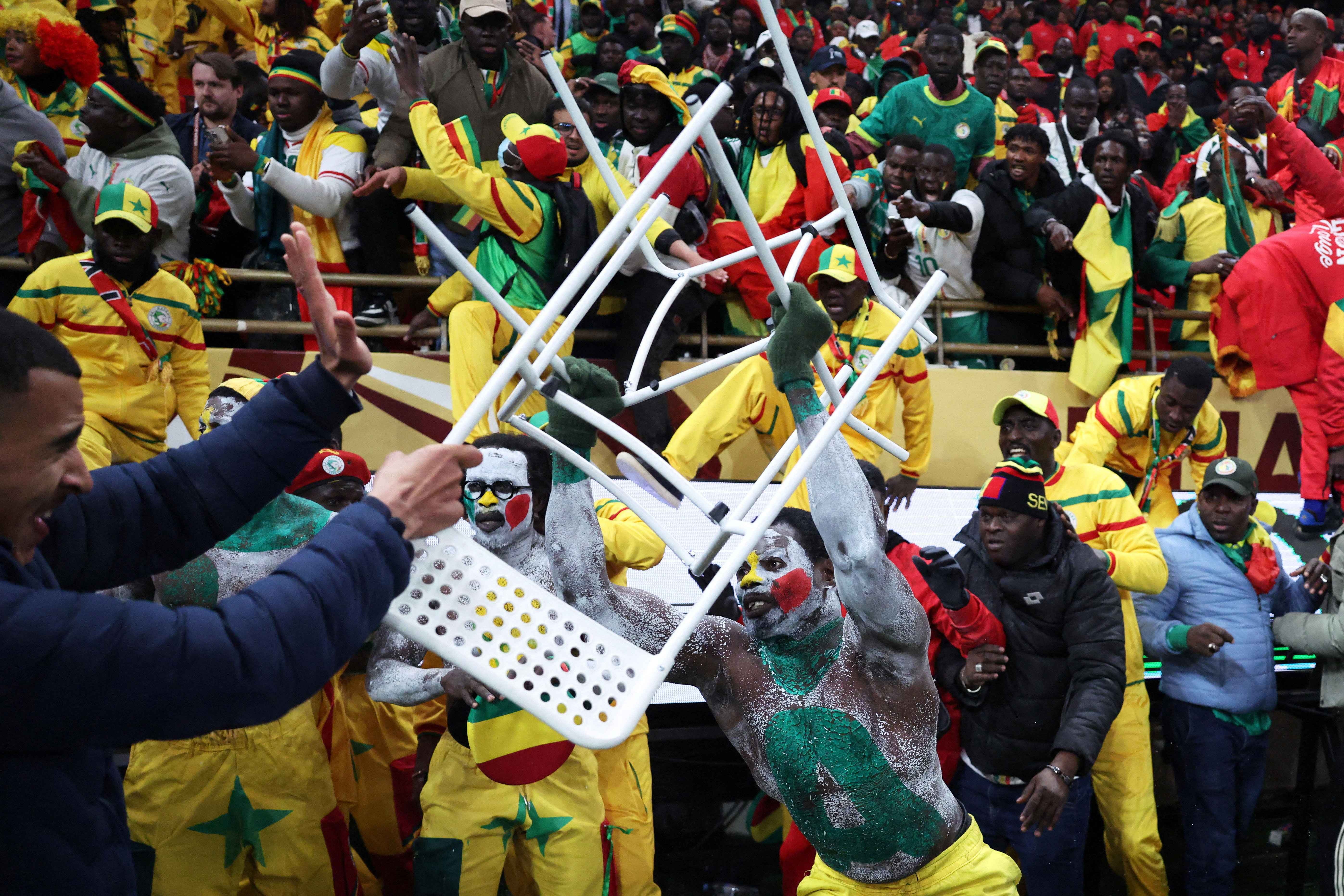 A Senegal fan clashes with security during the AFCON final