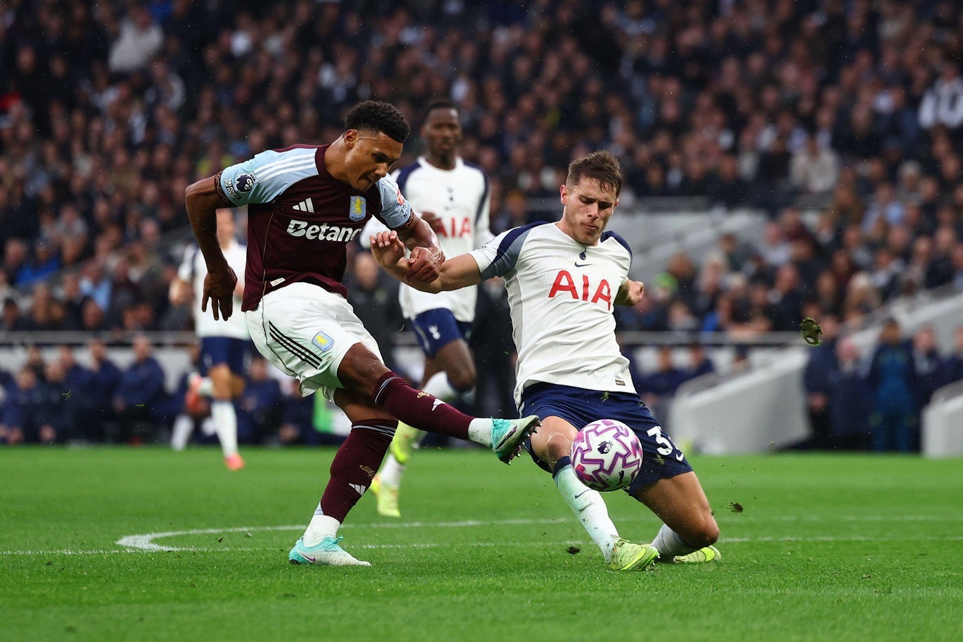 Aston Villa's Ollie Watkins (left) fires past Tottenham's Micky van de Ven earlier this season