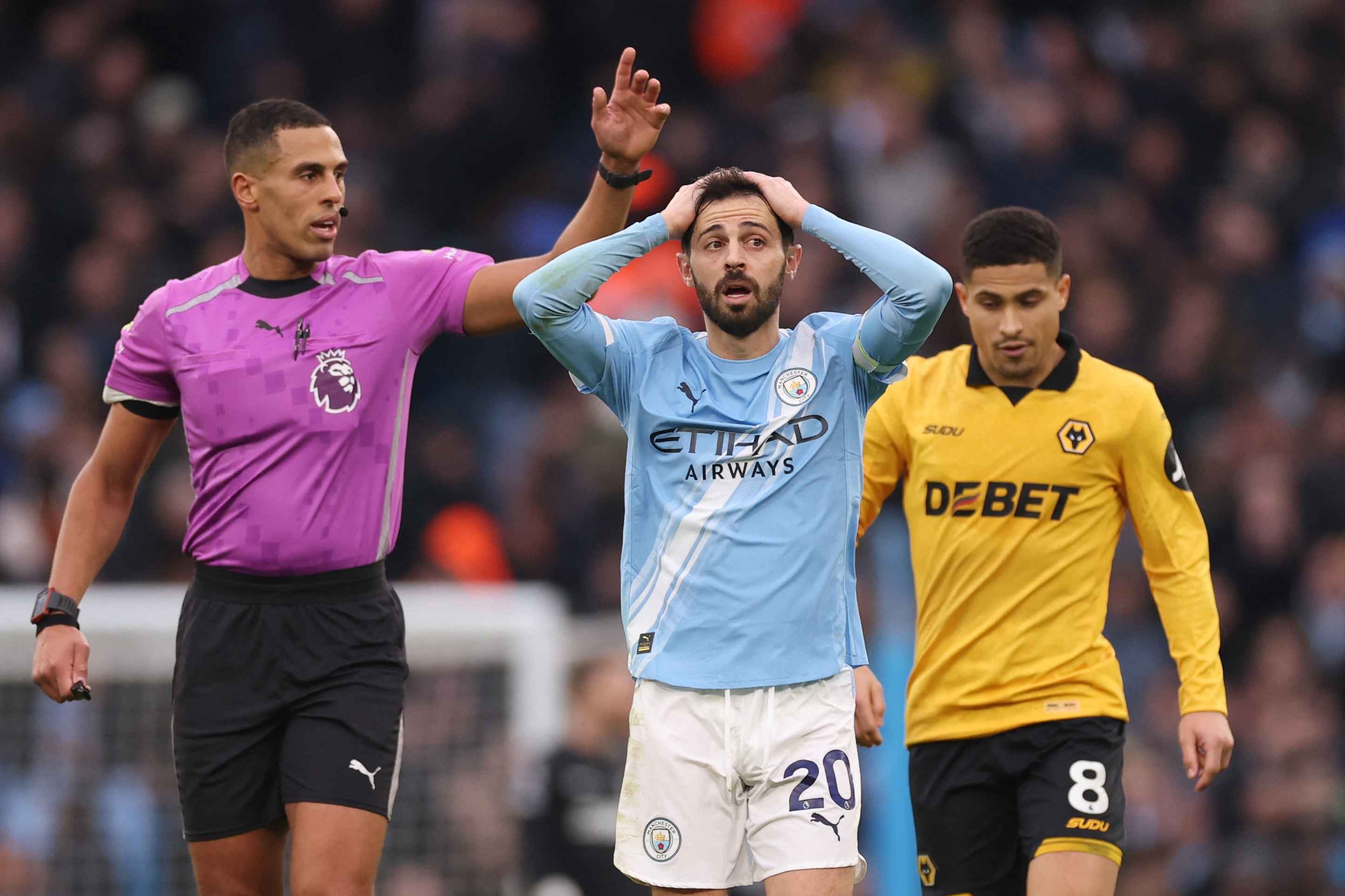 Bernardo Silva reacts after referee Farai Hallam fails to overturn his penalty decision against Wolves