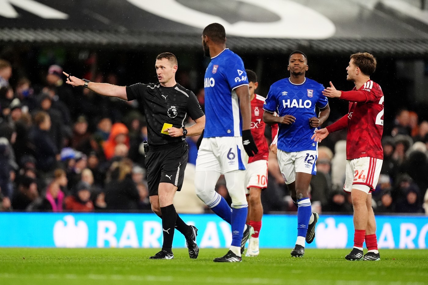 Referee Thomas Bramall (left) shows a yellow card to Ipswich Town's Issa Diop after a VAR check.
