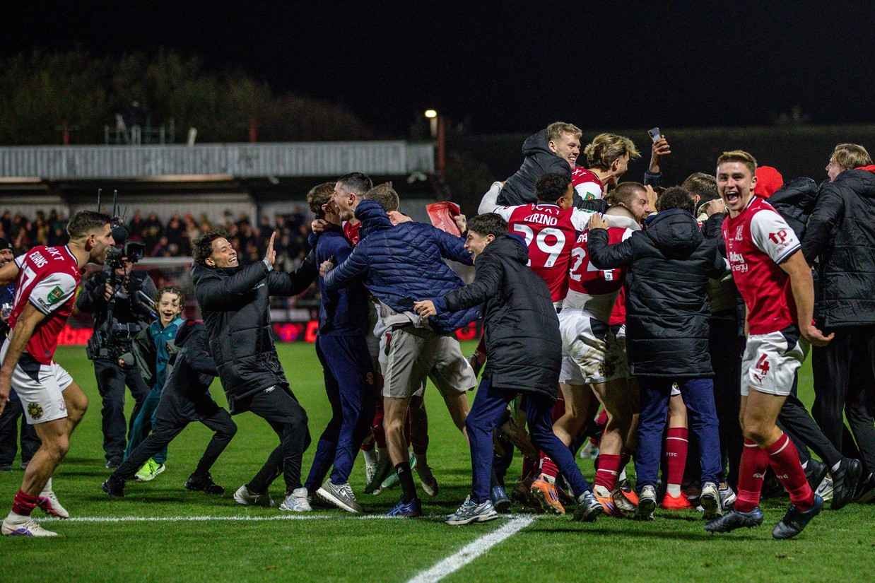 Fleetwood Town celebrate winning the penalty shootout against Arsenal with their fans