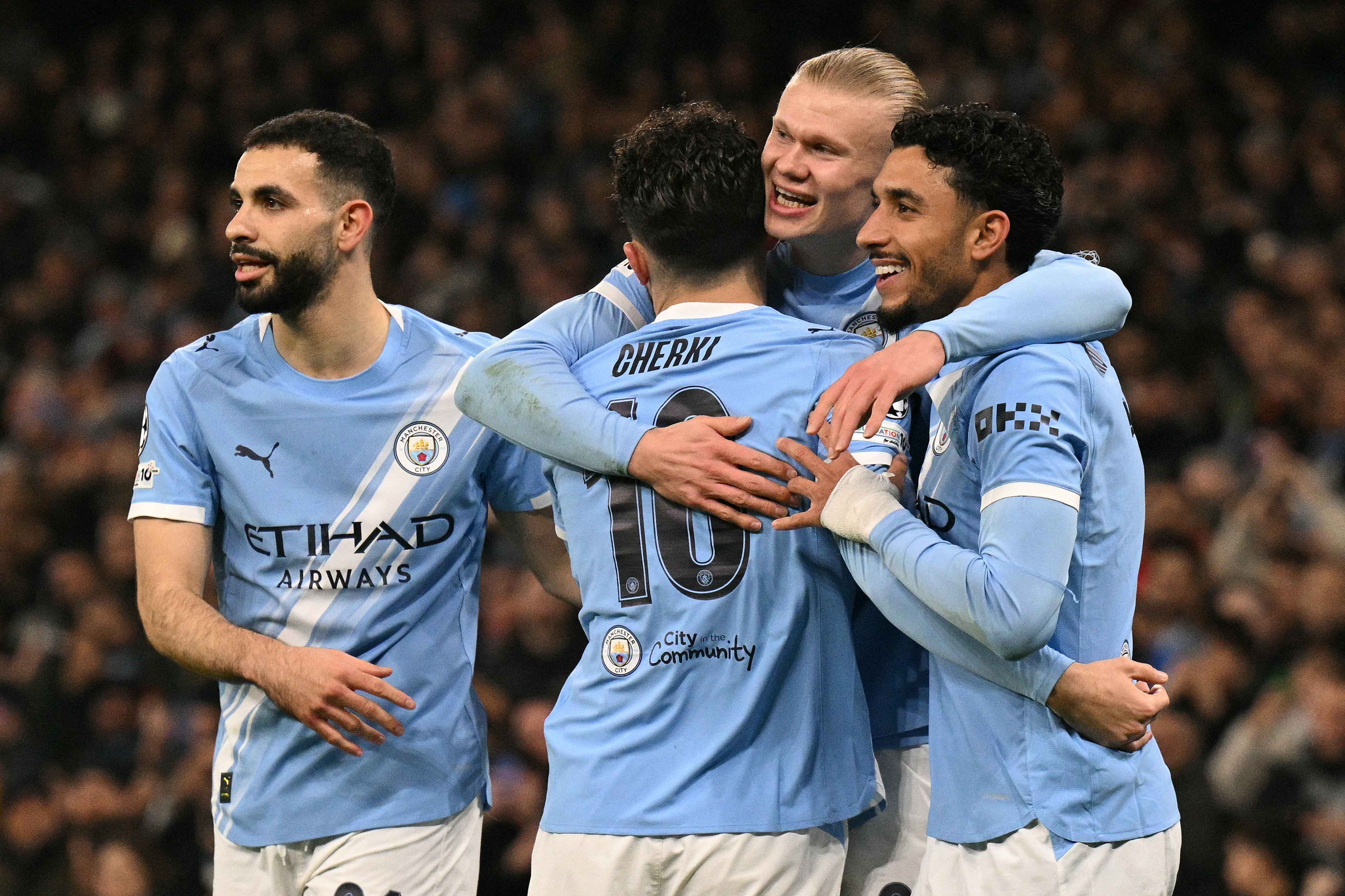 Manchester City mob Erling Haaland after the striker scored their first goal