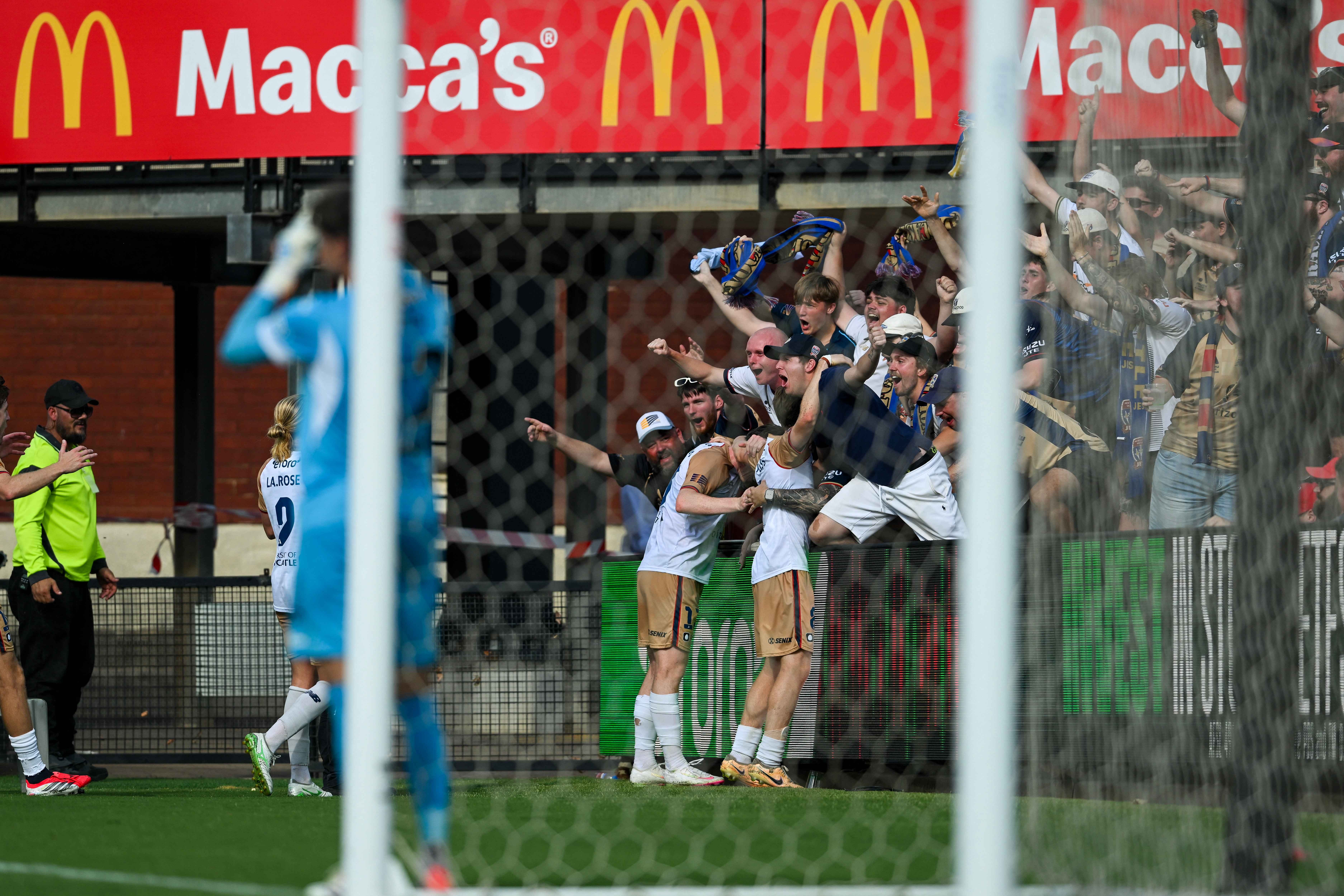 Newcastle Jets forward Clayton Taylor celebrates his second of his three goals with the away fans in Adelaide.