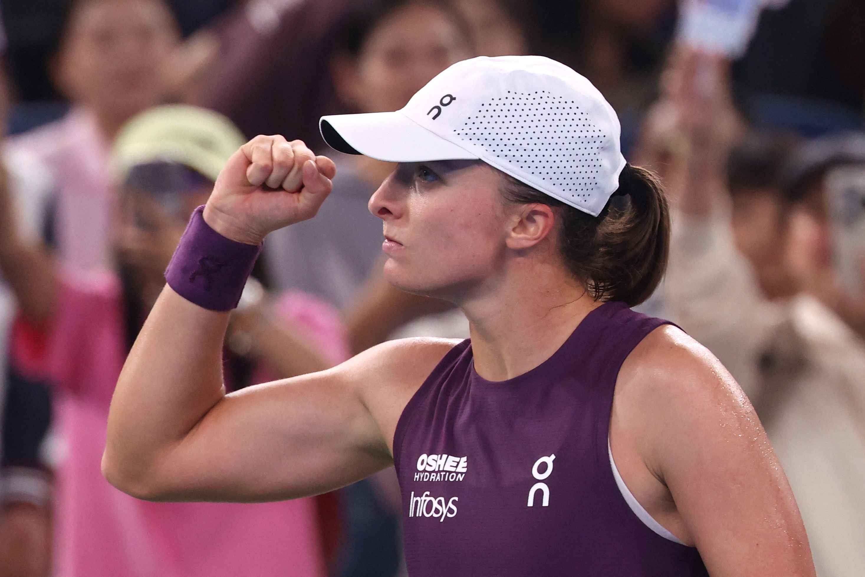 Iga Swiatek celebrates winning her quarterfinal match against Ann Li in Wuhan