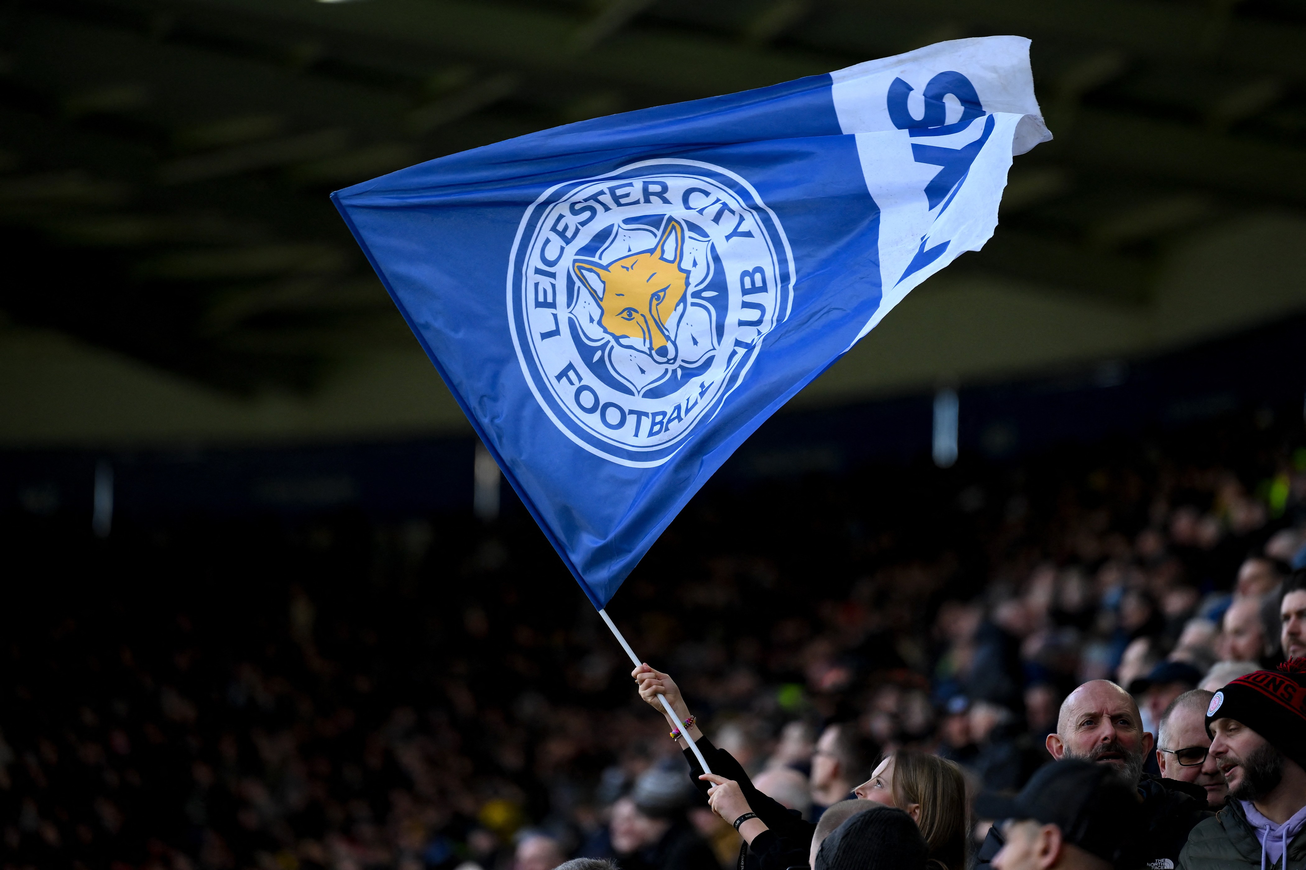 A Leicester City supporter waves a flag