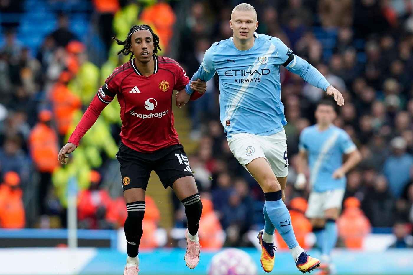 Manchester United's Leny Yoro and Manchester City's Erling Haaland battle for the ball
