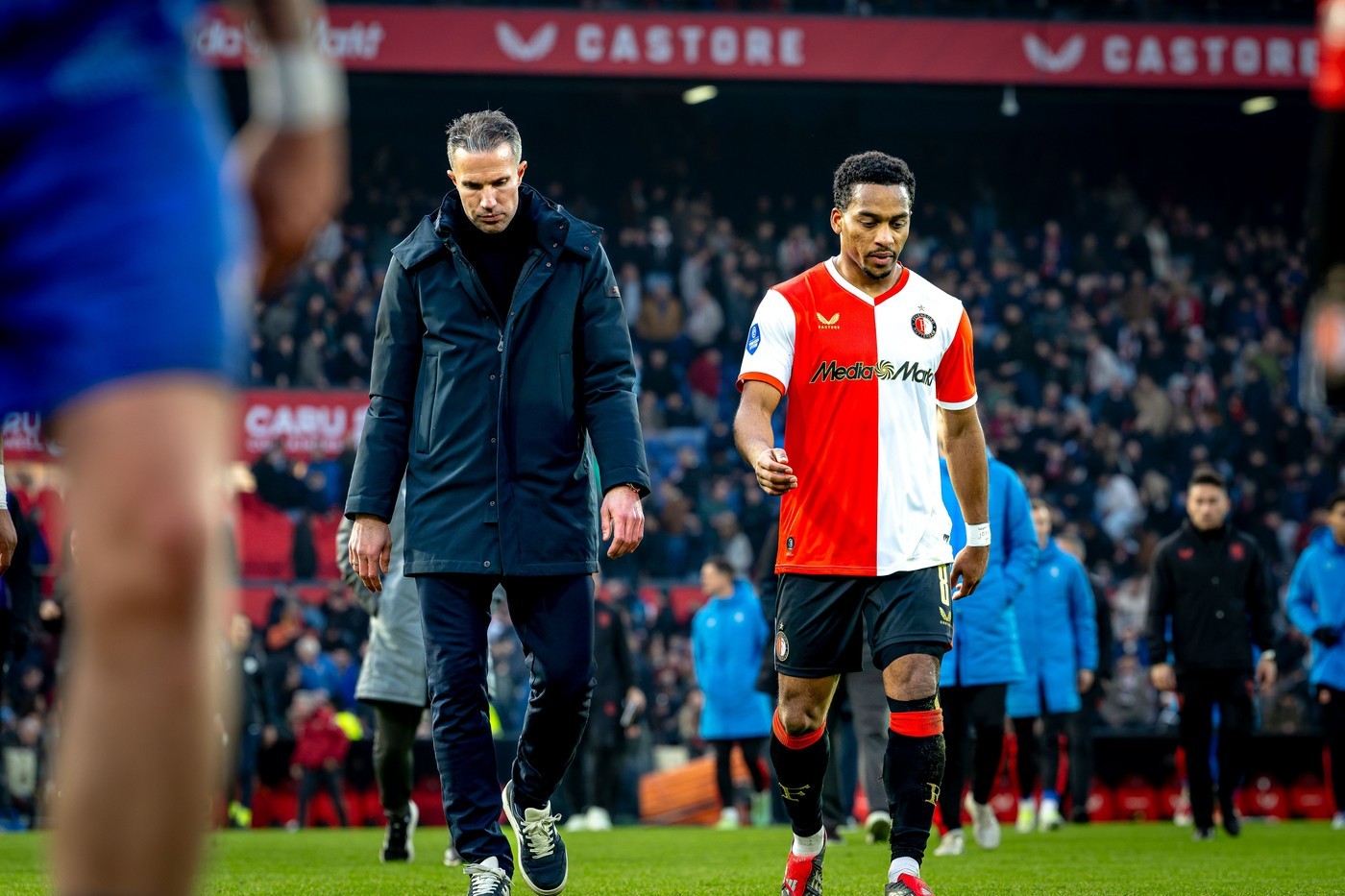 Feyenoord's Quinten Timber (R) walks beside manager Robin van Persie