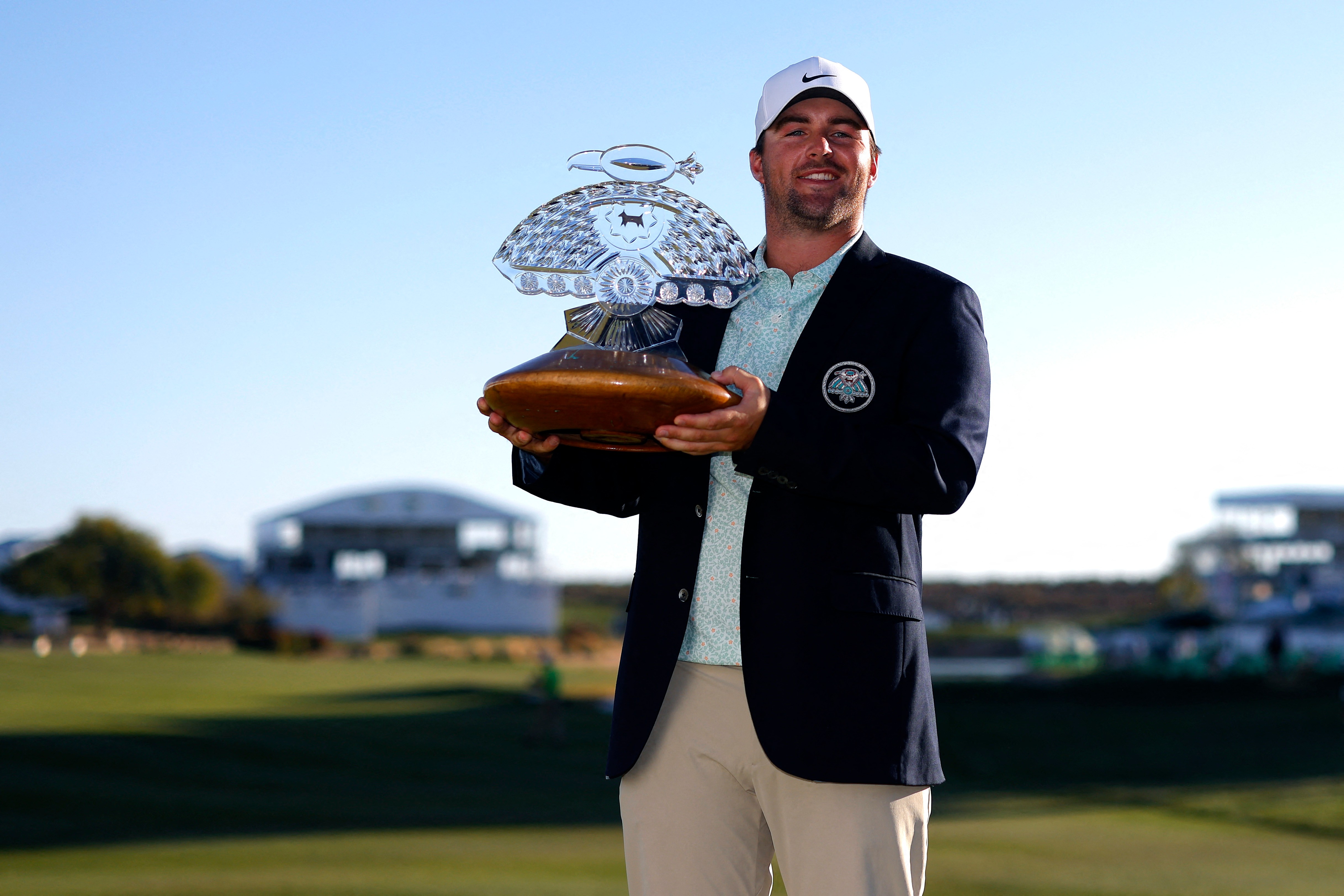 Chris Gotterup poses with the trophy after winning the Phoenix Open.
