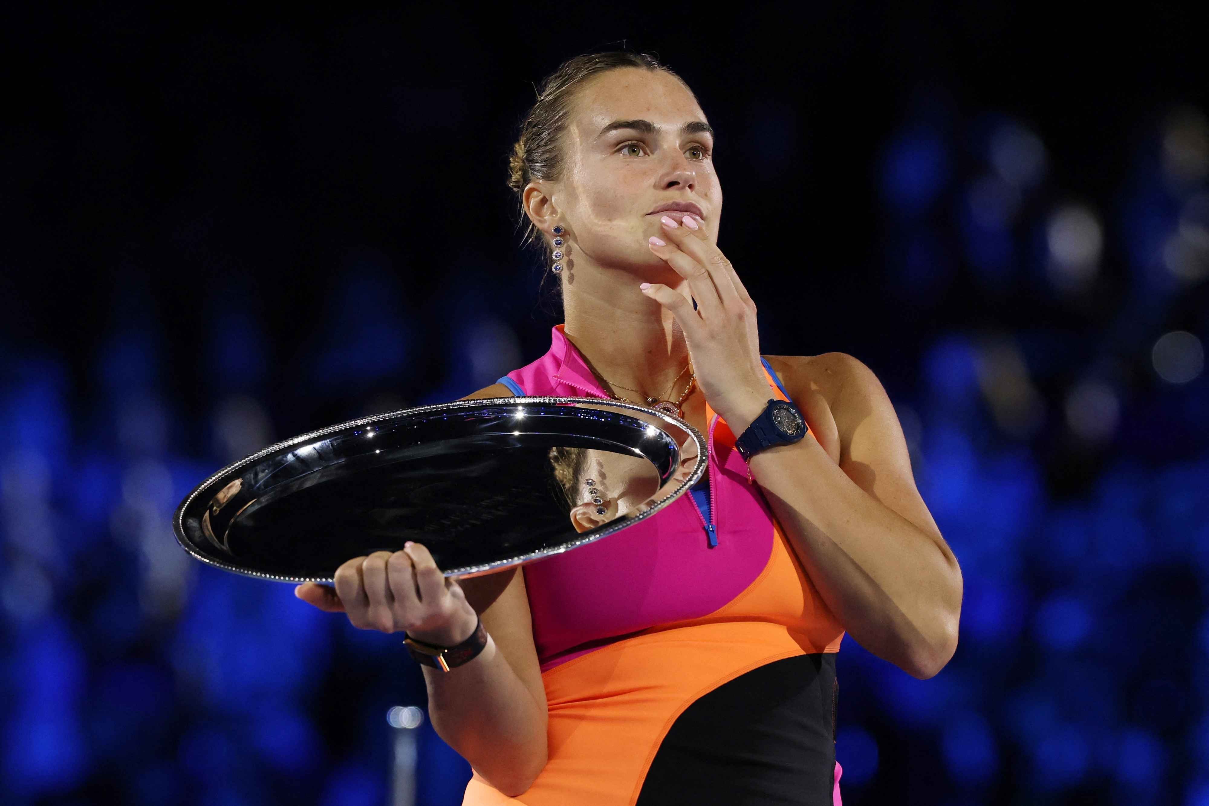 Aryna Sabalenka on the podium with the runner-up trophy after the women's singles final against Elena Rybakina