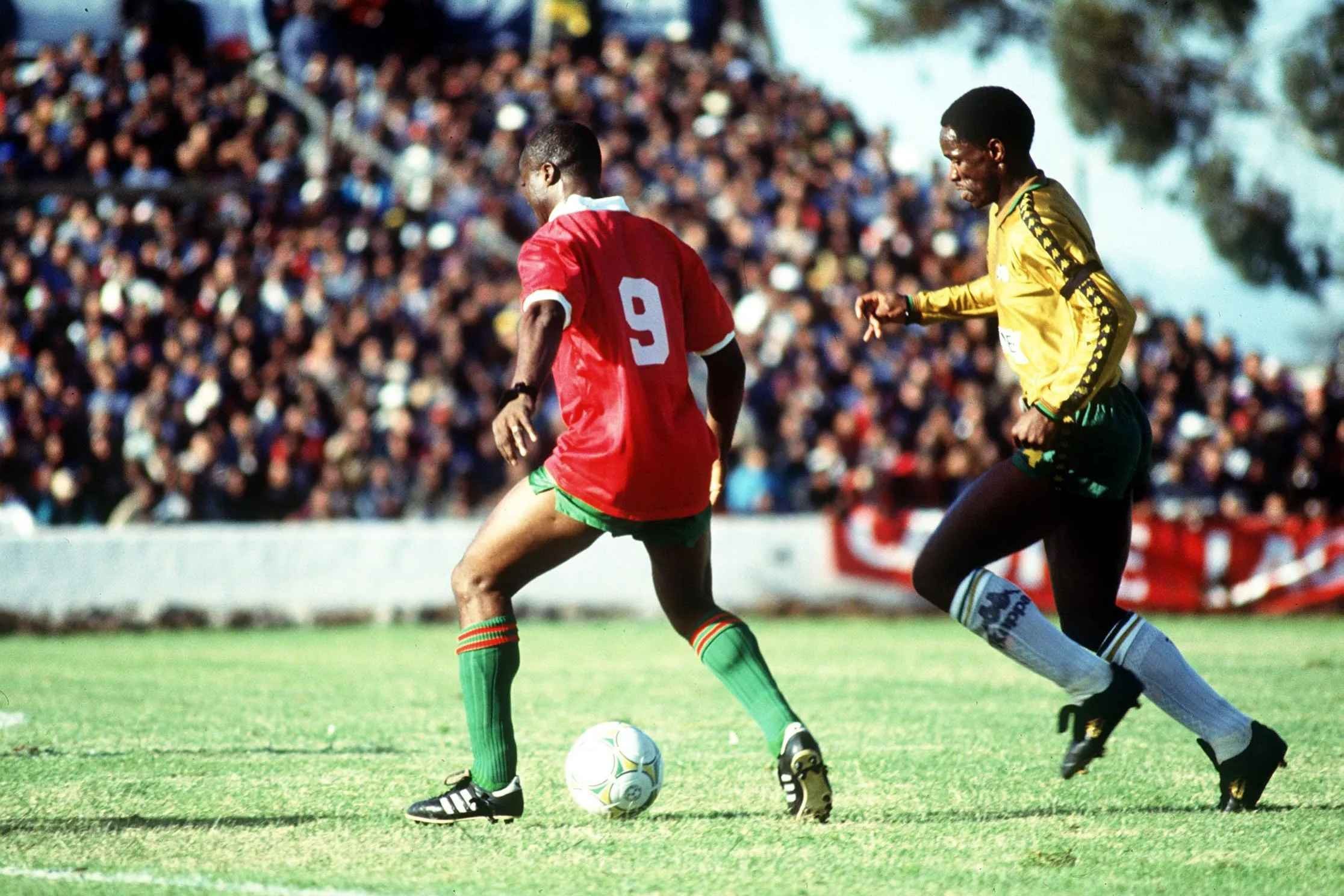 Steve Komphela challenges Roger Milla in the second match of the 1992 series against Cameroon