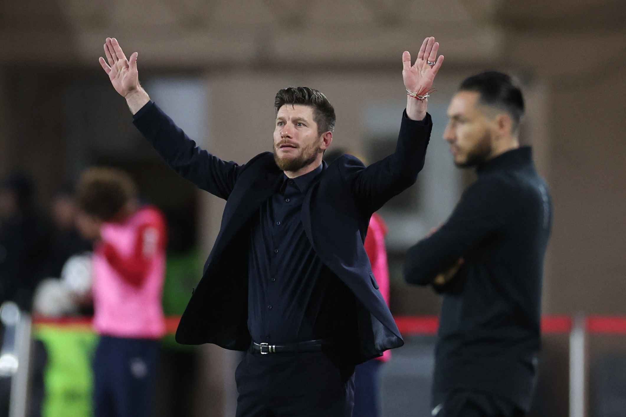 Pocognoli reacts on the touchline