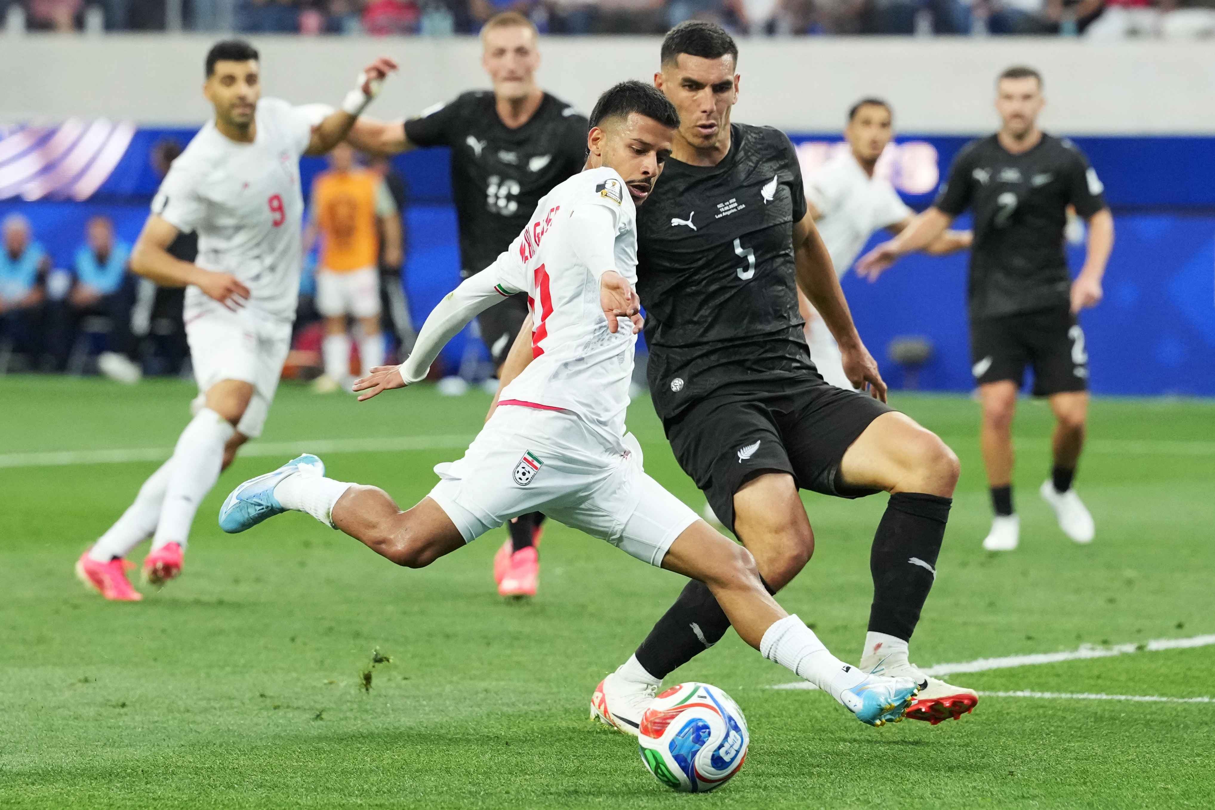 Iran's Mehdi Ghayedi takes a shot against New Zealand's Michael Boxall 