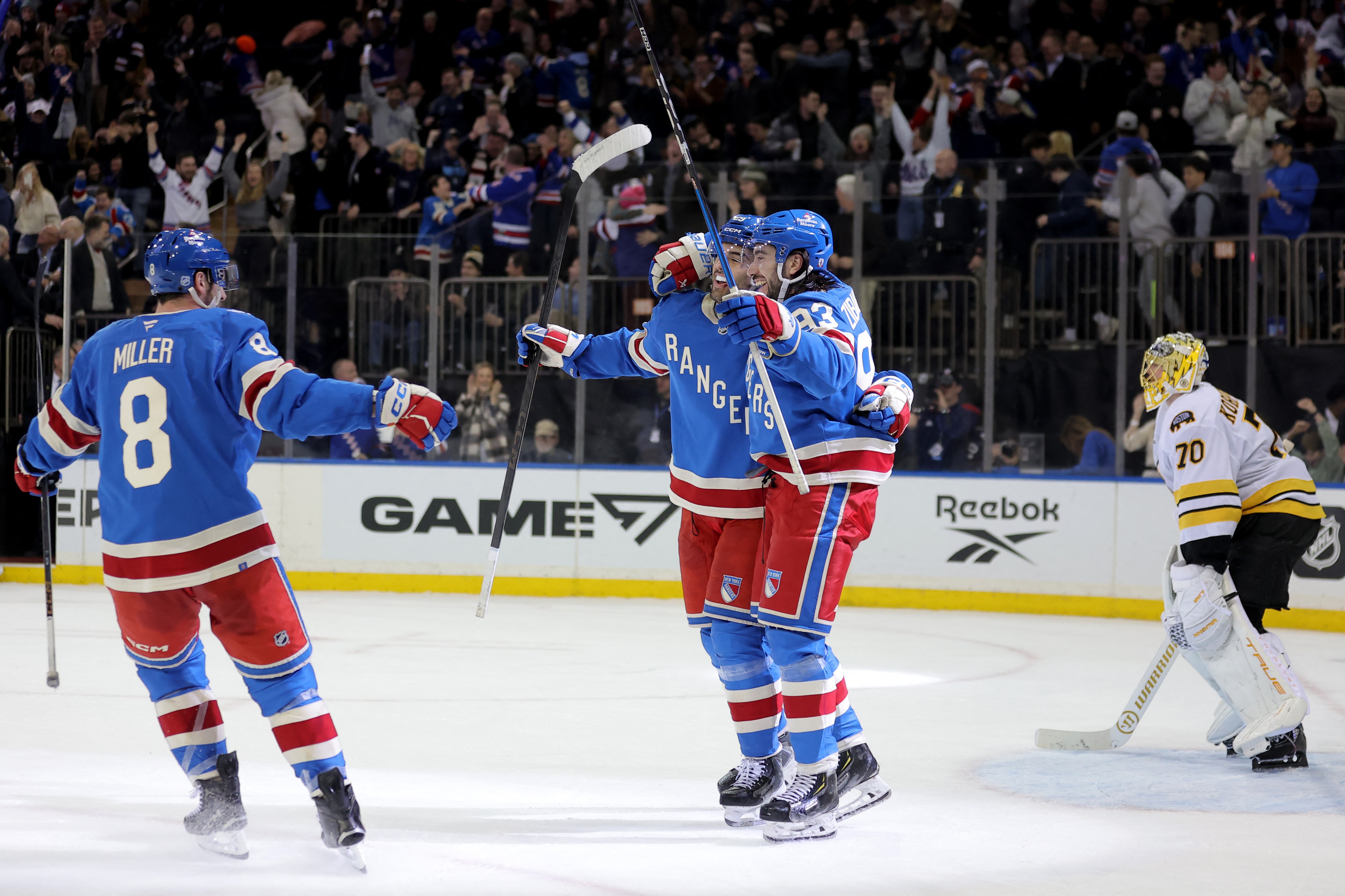 The New York Rangers celebrate a goal during their win over the Boston Bruins in the NHL.