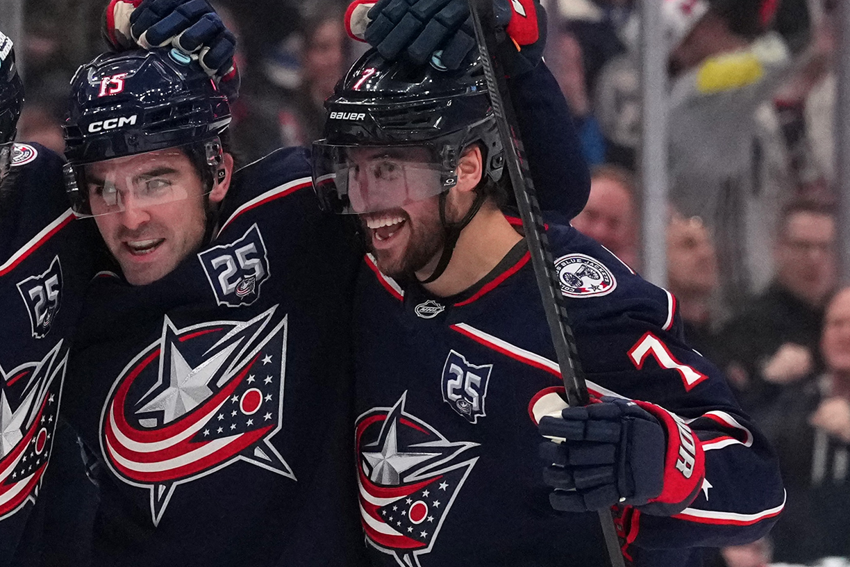 Blue Jackets defenceman Brendan Smith (right) celebrates a goal with teammates
