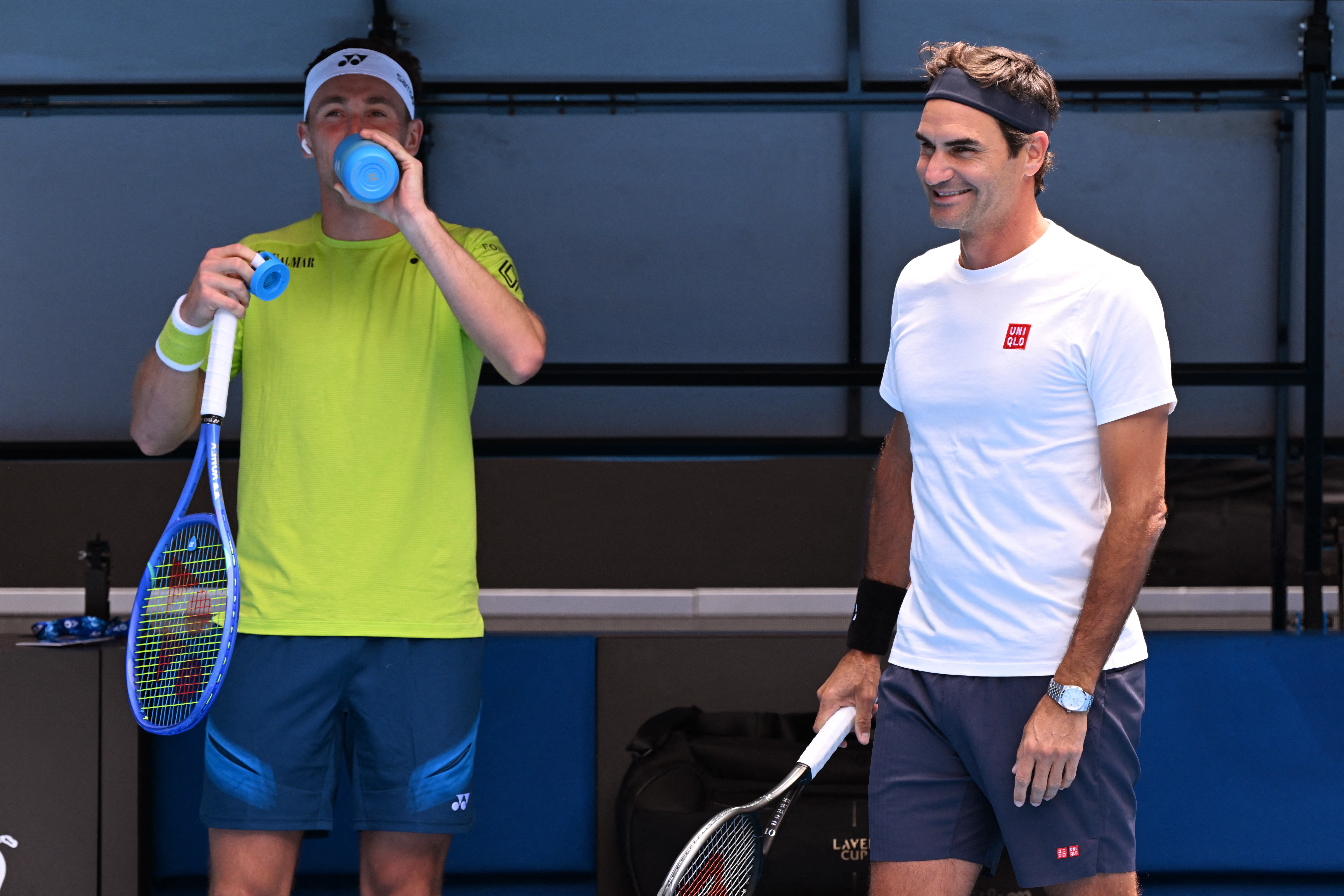 Casper Ruud chats with Roger Federer during their practice match in Melbourne on Friday.