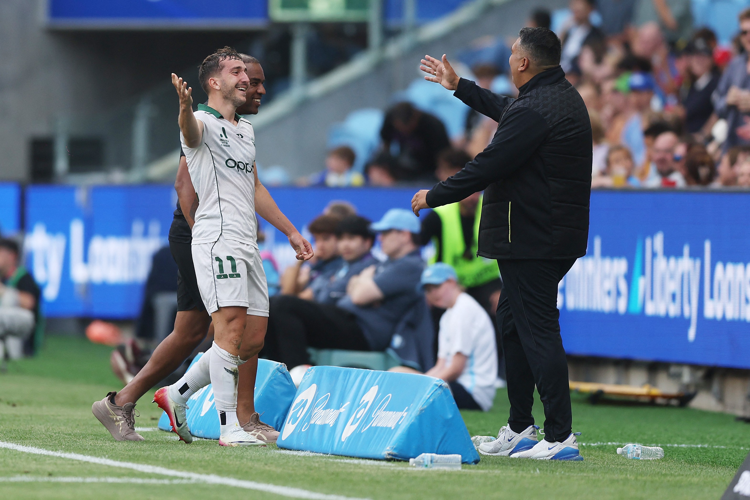 Wellington head coach Giancarlo Italiano celebrates a goal with Carlo Armiento.