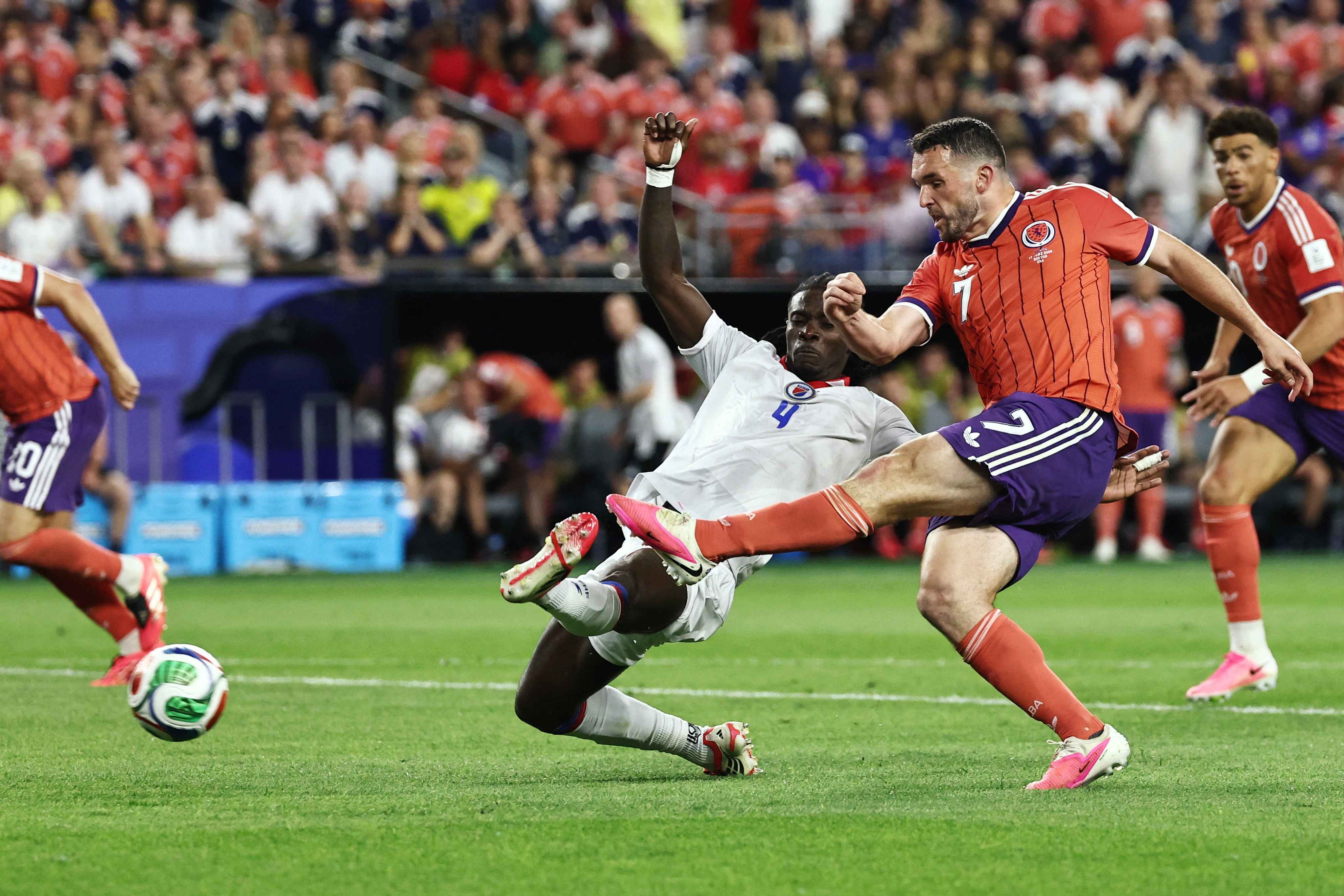 John McGinn slides home his winner against Haiti 