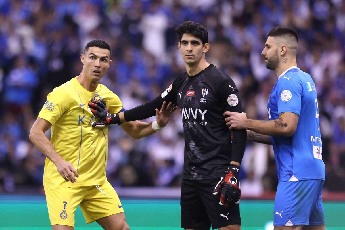 Al Hilal's Ali Al Bulayhi, right, fights for the ball with Urawa