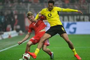 Dortmund's Nmecha battles for the ball