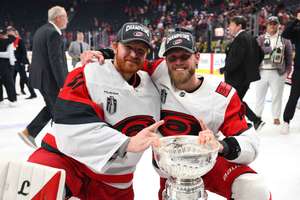 Frederik Andersen and Nikolaj Ehlers of the Carolina Hurricanes pose with the Stanley Cup after Game Six