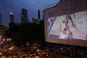 New York Knicks fans watch their team on the big screen during Game 4 of the NBA Finals.