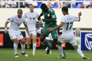 Oluwaseyi Olofinjana (centre) of Nigeria fights for the ball with Samir Zaoui (right) and Yazid Mansouri (left) of Algeria in 2010.