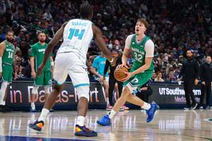 Dallas Mavericks forward Cooper Flagg looks to shoot as Charlotte Hornets forward Moussa Diabate defends