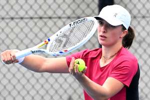 Poland's Iga Swiatek serves during a practice session ahead of the United Cup tennis tournament in Sydney