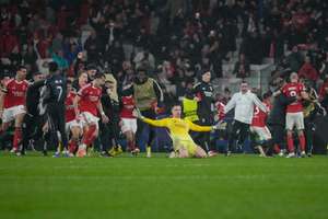 Benfica players celebrate a last-minute goal against Real Madrid