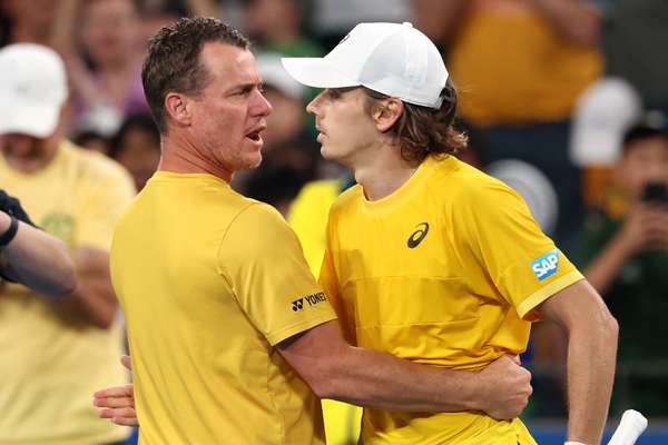 Alex De Minaur embraces team captain Lleyton Hewitt after defeating Zizou Bergs last year.