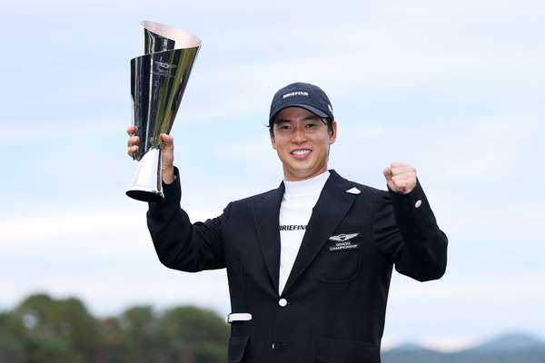 Yuto Katsuragawa celebrates with the trophy after winning the Genesis Championship