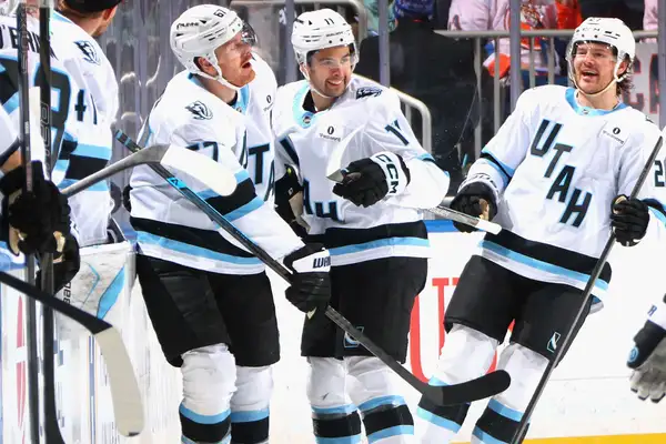 Dylan Guenther (centre) celebrates his first career hat trick (2026)