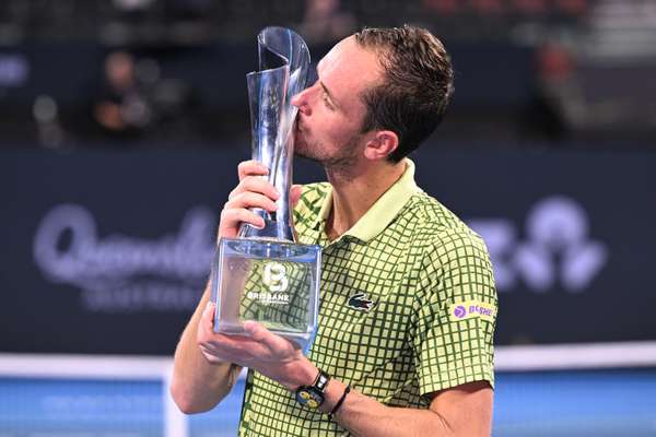 Daniil Medvedev embraces the 2026 Brisbane International trophy. 