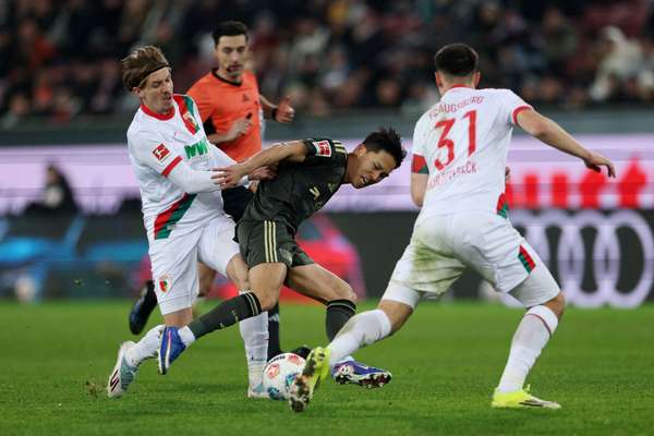 Kristijan Jakic of Augsburg fouls Jeong Woo-Yeong