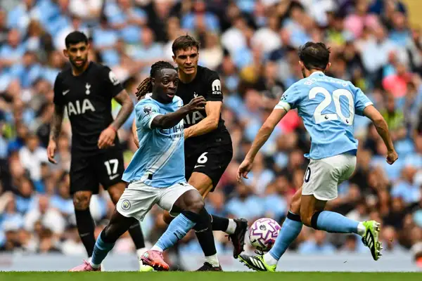 Manchester City's Jeremy Doku under pressure from Tottenham's Joao Palhinha