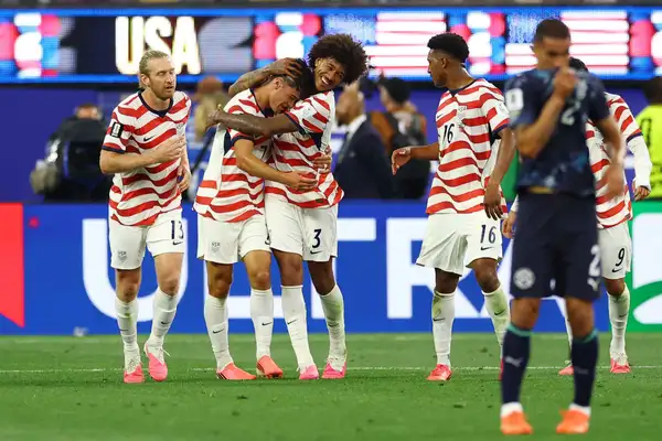 Chris Richards celebrates with Gio Reyna after the US net their fourth against Paraguay