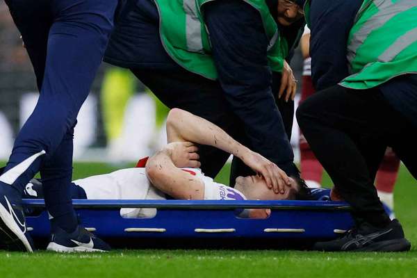 Ben Davies is stretchered off during the game against West Ham