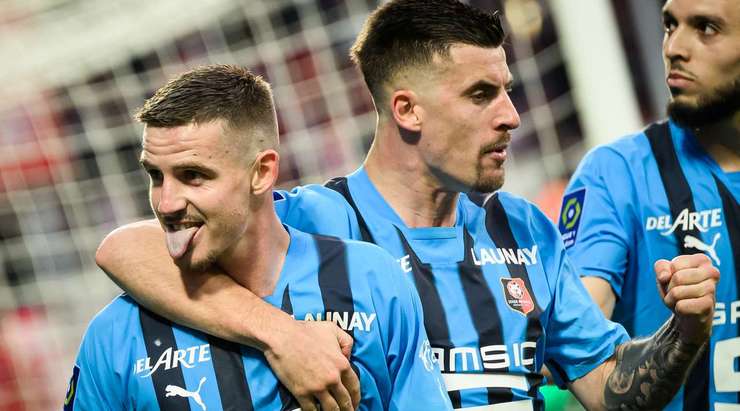 Vào! Marco Bizot đã chạm được những đầu ngón tay vào bóng sau cú sút của Benjamin Bourigeaud (Rennes), nhưng chừng đó thôi không đủ ngăn trái bóng đi vào góc cao bên phải khung thành.