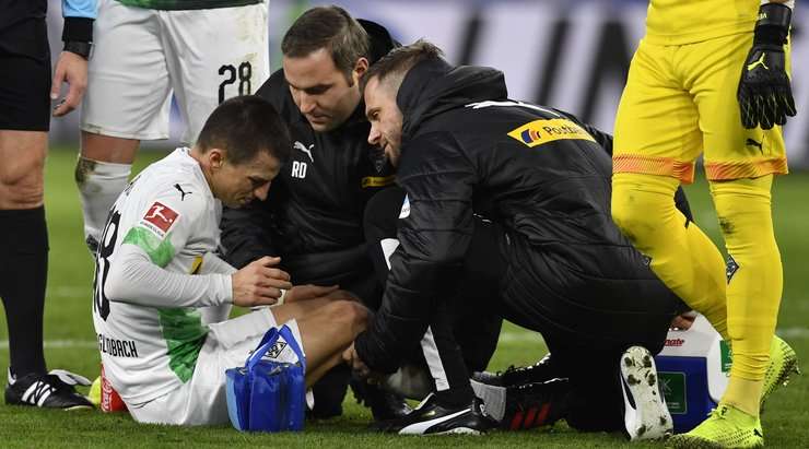 Stefan Lainer (B. Monchengladbach) đang nằm sân sau pha tranh bóng trước đó và đội ngũ y tế đang được gọi vào để giúp anh ấy.