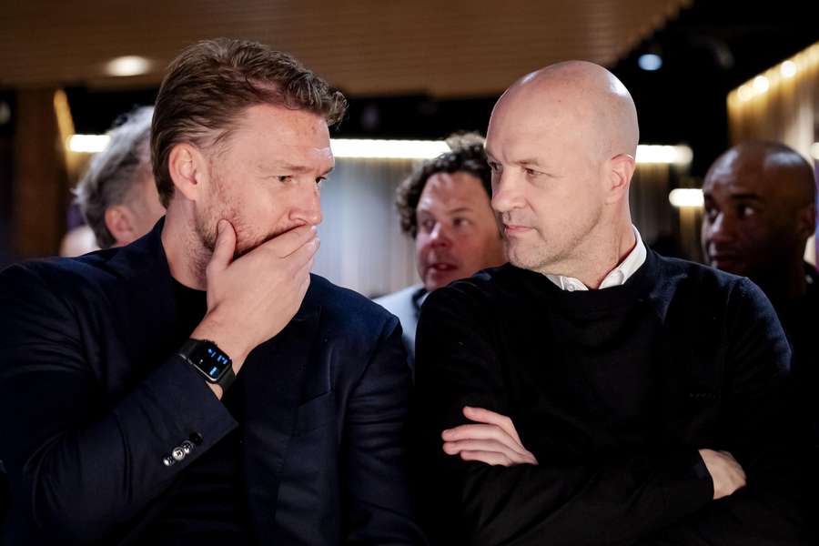 Ajax's Director of Football, Marijn Beuker (L), talks with technical director Jordi Cruyff