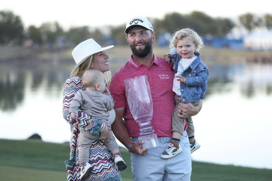 Jon Rahm (2nd R) celebrates with the trophy alongside wife Kelley (2nd L), sons Kepa Cahill Rahm (R) and Eneko Cahill Rahm (L)