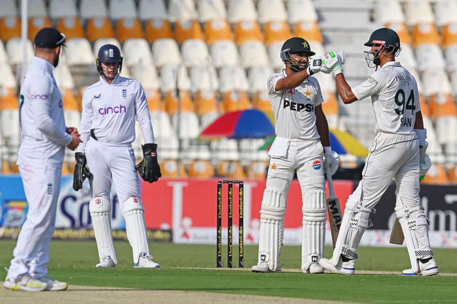 Pakistan's Abdullah Shafique celebrates with his captain Shan Masood after scoring a century