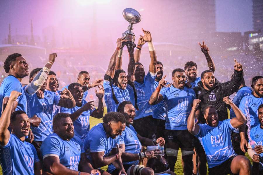 Fijian players enjoy the trophy after their victory over Japan in Tokyo. Fijian players enjoy the trophy after their victory over Japan in Tokyo.